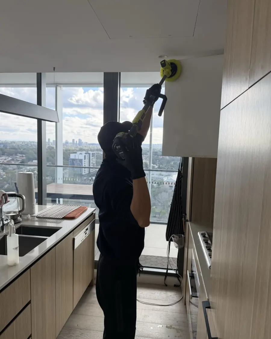Degreasing a rangehood in a high-rise apartment kitchen